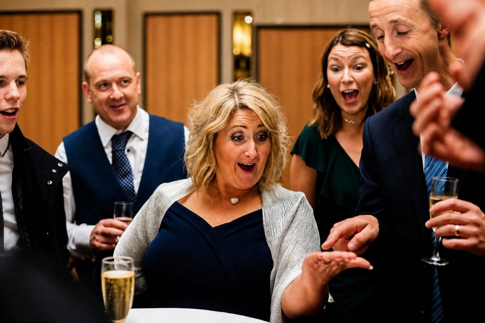 Guests reacting to close-up magic at a corporate event