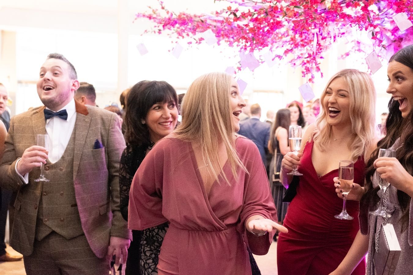 Guests reacting to a corporate magician at a drinks reception