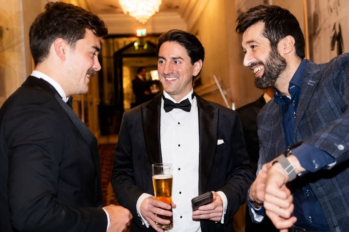 Corporate magician entertaining a standing group at a company event