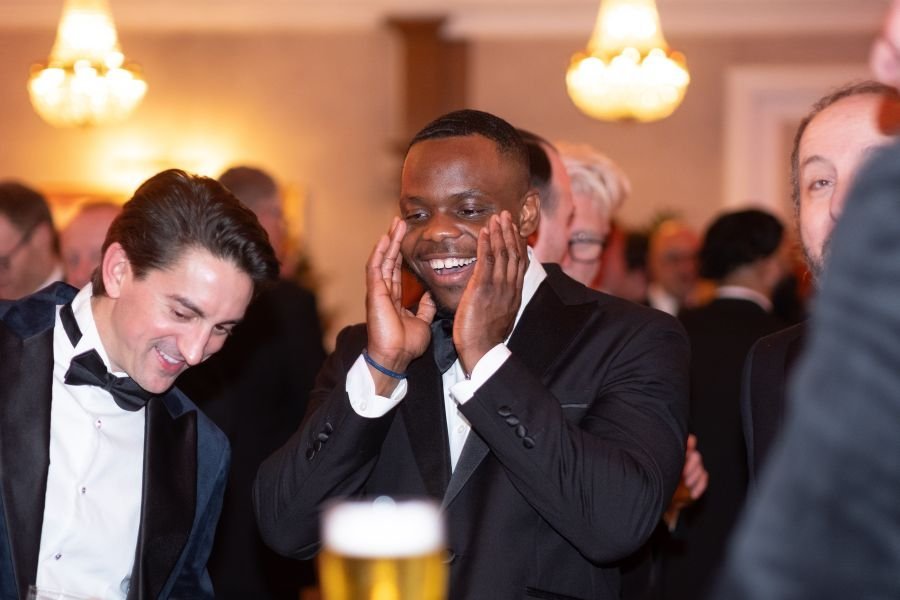 Corporate event guests gathered around a magician